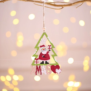 Wooden cutout Christmas tree ornament with Santa and XMAS text hanging on a branch