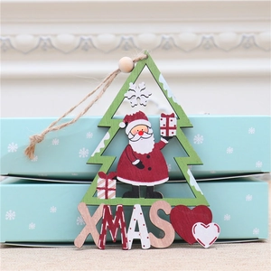 Detail of wooden Christmas tree ornament featuring Santa Claus and XMAS lettering