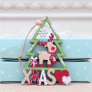 Detailed wooden Christmas tree ornament with reindeer cutout and XMAS letters on top of a box