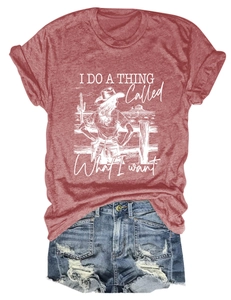 Close-up of red heather T-shirt with cowboy graphic and distressed denim shorts