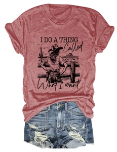 Detail of reddish-brown vintage t-shirt with desert graphic and blue denim shorts
