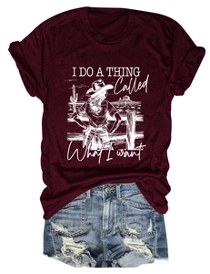 Close-up of maroon cotton t-shirt with vintage cowboy graphic and white slogan