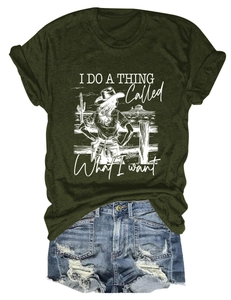 Detail of olive green t-shirt with white western graphic print and distressed denim shorts
