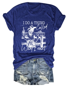 Close-up of a navy blue graphic t-shirt and distressed denim shorts in flat lay style