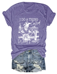 Close-up of purple crew neck t-shirt with western desert graphic and denim shorts