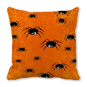 Close-up of Halloween pillow cover featuring black cartoon spiders on orange spiderweb fabric
