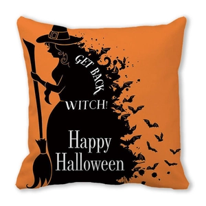 Detail of orange Halloween cushion cover featuring black witch and bat silhouette designs
