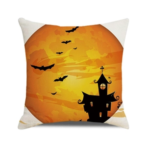 Close-up of Halloween pumpkin castle print on textured linen-style cushion cover