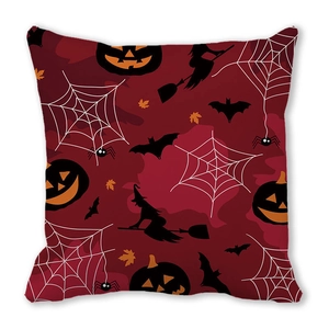 Close-up of Halloween pillow cover featuring wizard, pumpkin, and bat on dark red fabric