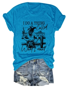 Flat lay of bright blue T-shirt featuring a western cactus graphic and distressed denim shorts