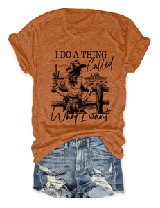 Flat lay of burnt orange vintage graphic T-shirt with distressed denim shorts set