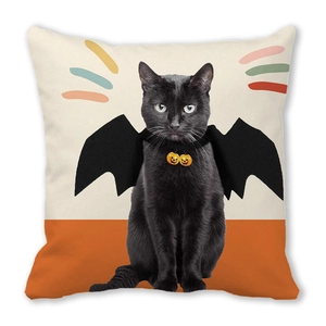 Detailed view of Halloween throw pillow with black cat and bat wings on peach skin fabric