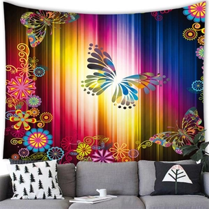 Detailed view of bohemian butterfly wall tapestry hanging above a modern grey sofa