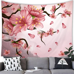 Detailed view of pink cherry blossom tapestry hanging above a modern sofa in a living room
