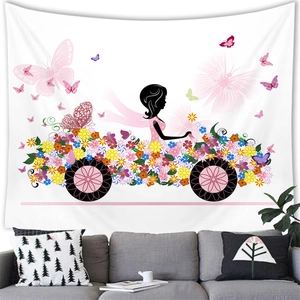 Floral butterfly silhouette girl tapestry hanging over a grey sofa in a modern white room
