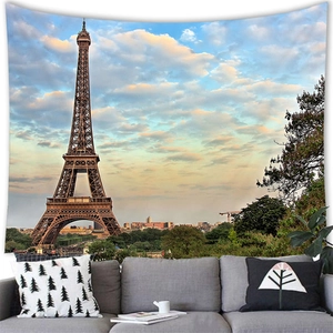 Eiffel Tower wall tapestry hanging in a cozy living room setup above a sofa