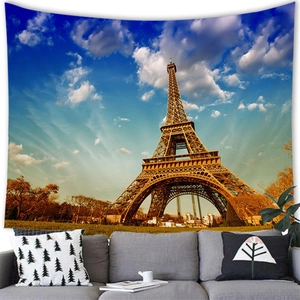 Eiffel Tower wall tapestry hanging above a gray sofa in a modern minimalist living room