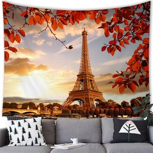 Eiffel Tower tapestry hung over a grey sofa showing autumn leaves and sunset detail