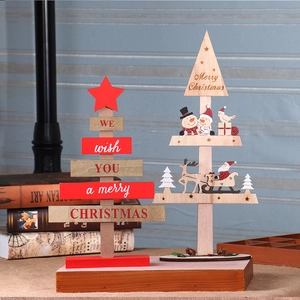 Detail of wooden Christmas tree ornaments with Santa and reindeer on a tabletop base