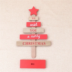 Flat lay of DIY wooden Christmas tree decor with red star topper and festive greetings