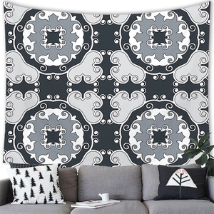 Detail of bohemian mandala tapestry featuring geometric patterns on home sofa wall