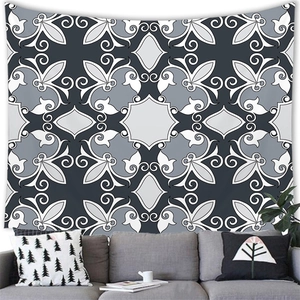 Detail of bohemian geometric tapestry hanging above a grey sofa in a modern living room