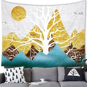 Artistic landscape tapestry with golden mountains and white trees above grey sofa