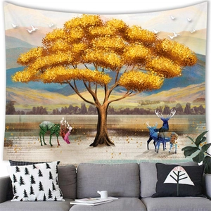 Modern wall tapestry featuring a golden landscape painting above a sofa in a cozy room