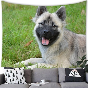Detail of soft fabric tapestry featuring a cute puppy sitting on green grass