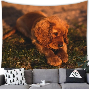 Detail of golden retriever tapestry hanging above a grey sofa in a cozy living room