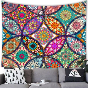 Bohemian mandala tapestry with colorful geometric floral patterns above a sofa