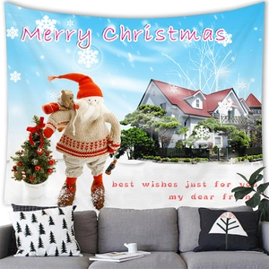 Merry Christmas wall tapestry featuring Santa Claus and snowman over a gray living room sofa