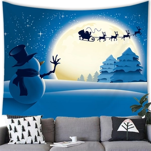 Detail of Christmas snowman tapestry hanging above a grey sofa in a cozy living room setting