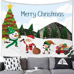 Detail of Christmas snowman and Santa tapestry hanging above a cozy grey fabric sofa