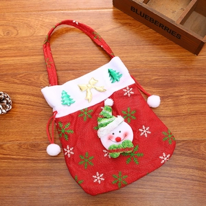 Macro detail of red Christmas gift bag with 3D snowman and festive snowflake patterns
