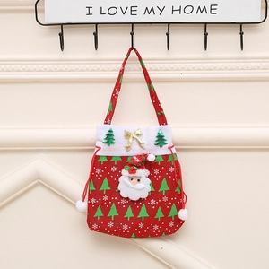 Detail of red Christmas drawstring gift bag with Santa Claus 3D doll and festive patterns