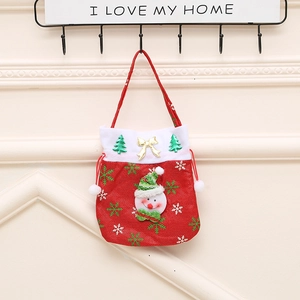 Detail of a red Christmas gift bag with a 3D snowman and white cuff hanging on a hook
