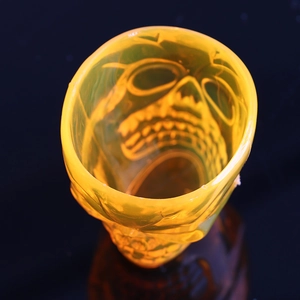 Detailed top view of a translucent yellow 3D skull mug with intricate gothic facial relief