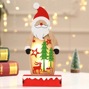 Detail of light-up wooden Santa ornament with hollow carved reindeer and warm LED glow