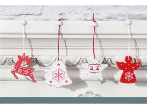 Detailed view of wooden Christmas ornaments hanging on a white fireplace mantel