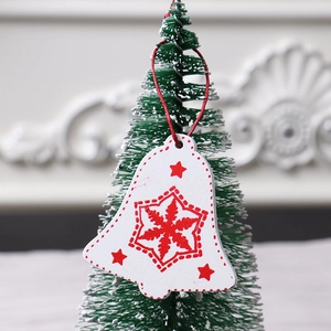 Wooden bell-shaped Christmas tree ornament with red snowflake and star patterns