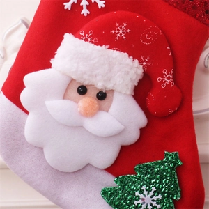 Close-up of 3D Santa Claus figure on a red and white felt Christmas stocking bag