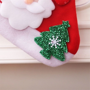Detail of 3D Santa plush Christmas stocking with green sequin tree and snowflake