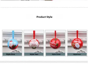 Detail of Christmas tin ball ornaments with Santa and reindeer prints and hanging ribbons