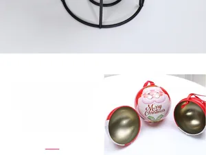 Detail of Santa Claus tin ball gift box with red ribbon and silver metal interior