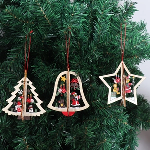 Detailed view of 3D laser-cut wooden Christmas tree, bell, and star ornaments on a branch