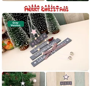 Close-up of wooden Christmas tree door hanging with star, bow, and bells in gray