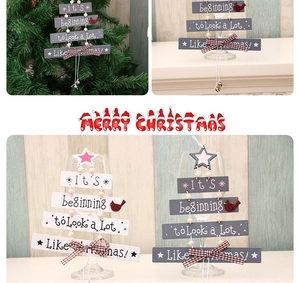 Detail of wooden Christmas tree hanging sign with festive text and plaid bow decoration