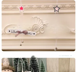Close-up of wooden Christmas tree ornaments with festive bells and plaid bows decorations