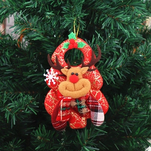 Detail of reindeer Christmas tree ornament with plush head and plaid bow tie decor